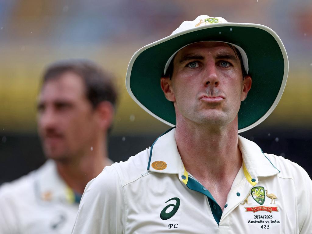 Pat Cummins walks off the Gabba during a rain delay. Picture: David Gray/AFP.