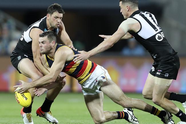 Crows Brad Crouch under pressure from Port Adelaide’s Travis Boak and Tom Rockliff in Showdown 46 at Adelaide Oval. Picture Sarah Reed