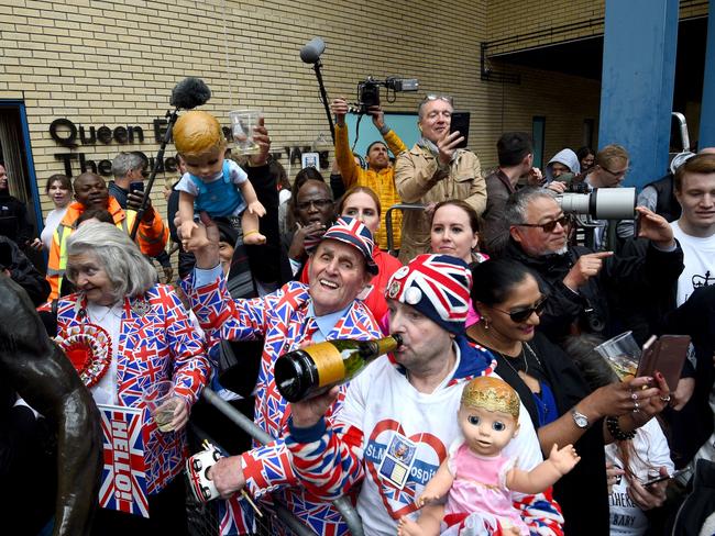 Royal fans celebrate outside the hospital in Paddington after the announcement the baby had been born around five hours after Kate arrived. Picture: Kirsty O'Connor/PA Images via Getty Images