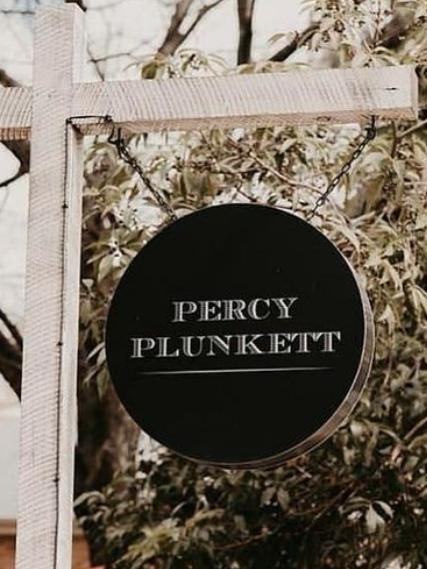 The elegant branded sign located outside Percy Plunkett.