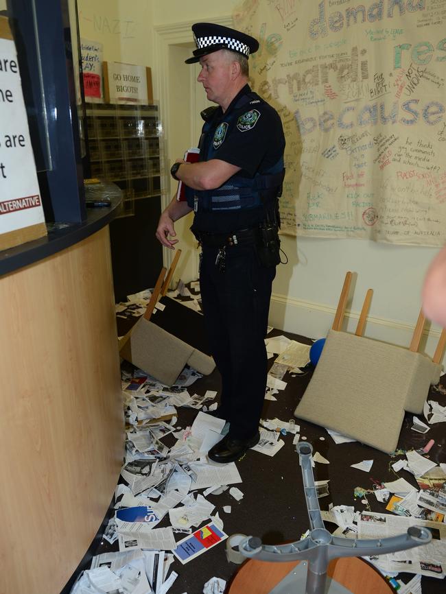 A police officer inspects the damage in Senator Cory Bernardi’s reception area. Picture: Mark Brake                        <a class="capi-image" capiId="82081c25c30af6a8453bdc580319914c"></a>