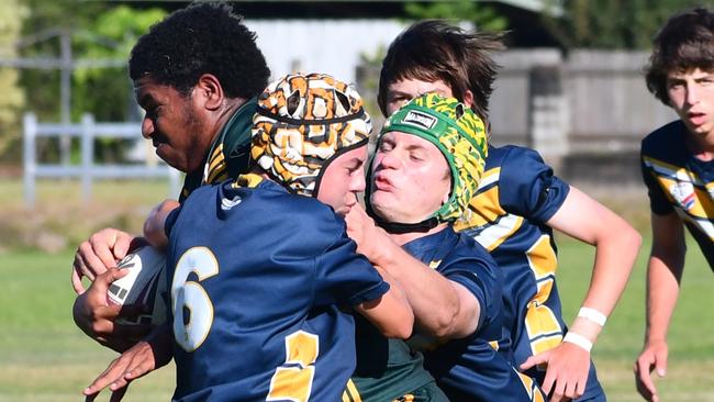 Israel George of Abergowrie is tackled by Jack Butcher and Kelin Corradi of Gilroy. Photos from the Will Murdoch Shield mini rugby league tournament involving the three Hinchinbrook high schools, Ingham State High School, Gilroy Santa Maria College and St Teresa's Catholic College Abergowrie, at Gilroy on Wednesday. Picture: Cameron Bates