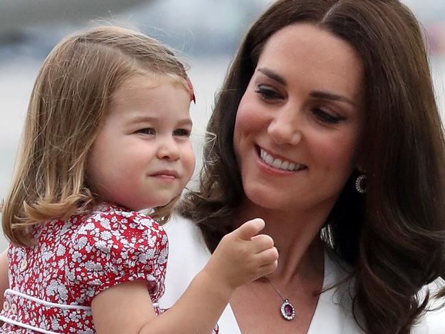 WARSAW, POLAND - JULY 17:  Catherine, Duchess of Cambridge carries Princess Charlotte of Cambridge as they arrive with Prince William, Duke of Cambridge and Prince George of Cambridge on day 1 of their offical visit to Poland on July 17, 2017 in Warsaw, Poland.  (Photo by Chris Jackson/Getty Images)