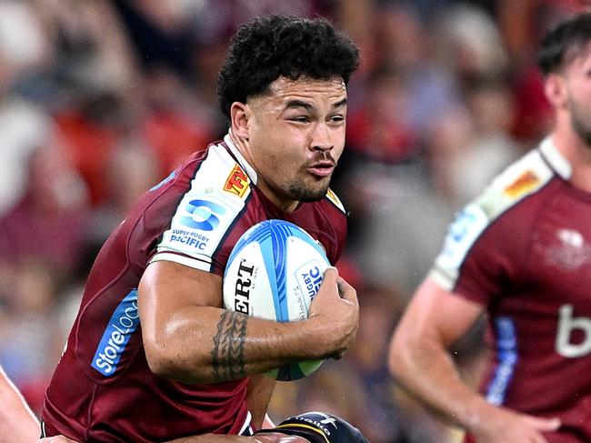 BRISBANE, AUSTRALIA - APRIL 19: Hunter Paisami of the Reds takes on the defence during the round nine Super Rugby Pacific match between Queensland Reds and Highlanders at Suncorp Stadium, on April 19, 2024, in Brisbane, Australia. (Photo by Bradley Kanaris/Getty Images)