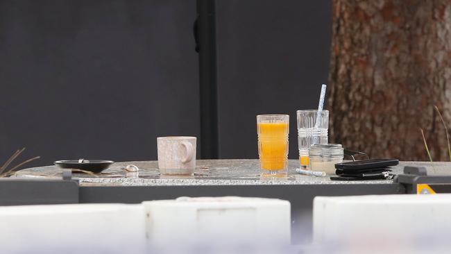 Unfinished drinks and belongings letft on the table after the shooting. Picture: David Crosling