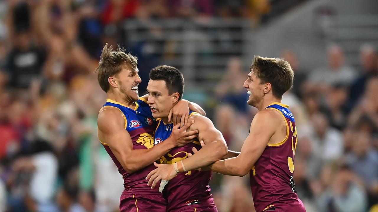 BRISBANE, AUSTRALIA - AUGUST 26: Hugh McCluggage of the Lions celebrates with team mates after kicking a goal during the round 24 AFL match between the Brisbane Lions and St Kilda Saints at The Gabba, on August 26, 2023, in Brisbane, Australia. (Photo by Albert Perez/AFL Photos via Getty Images)