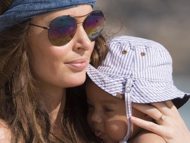 MUST CREDIT SPLASH WEB RIGHTS ONLY Nicole Trunfio, shows off her post baby body wearing a tiny navy Bikini on Bondi Beach, on Thursday. The new mum, also took baby Clark to the waters edge to dip his cute toes in the sea. Pictured: Nicole Trunfio and Baby Clark Ref: SPL1001049 160415 Picture by: Kate Dwek / Splash News Splash News and Pictures Los Angeles: 310-821-2666 New York: 212-619-2666 London: 870-934-2666 photodesk@splashnews.com