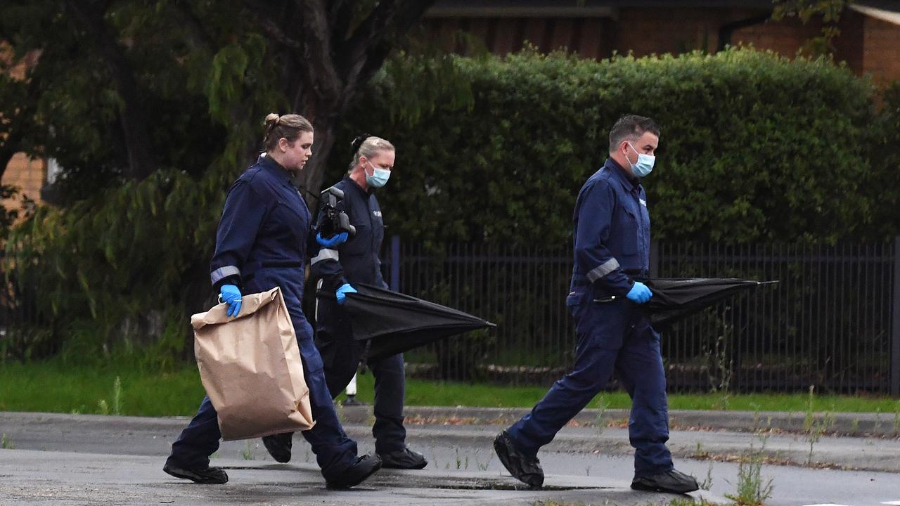 Police officers respond to reports of the injured man found beside the road. Picture: Josie Hayden