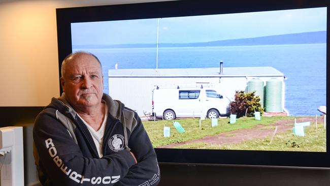 Barry Robertson with a picture of his shack. Picture: Brenton Edwards