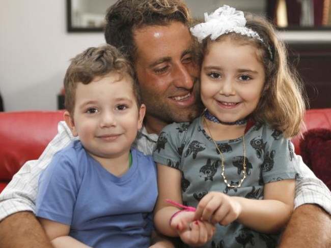 Noah (left) and Lahela with their father Ali Elamine in their family home in Beirut. Picture: Reuters/Mohamed Azakir