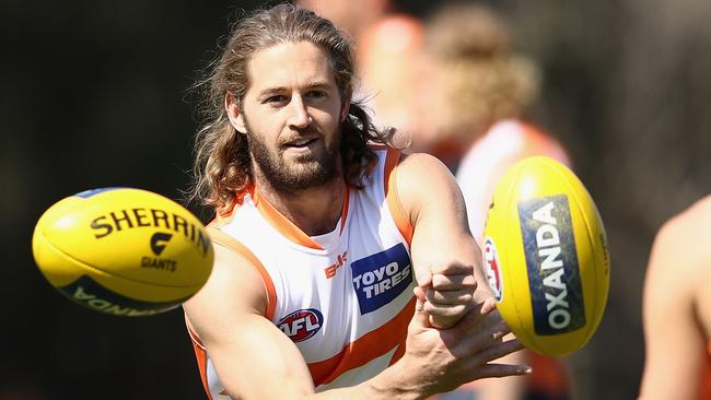 Callan Ward handballs during a Greater Western Sydney Giants AFL training session.