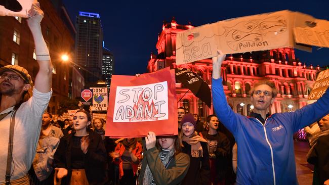 Anti-Adani coal mine protesters marching through the streets of Brisbane last week. Picture: AAP Image/Darren England