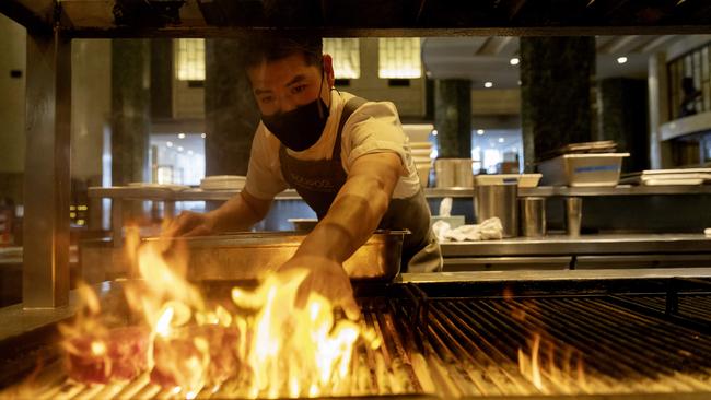 Chef Perry Chow prepares steak at Sydney’s Rockpool Bar &amp; Grill, ready for delivery to Neil Perry At Home customers. Picture: Nikki Short