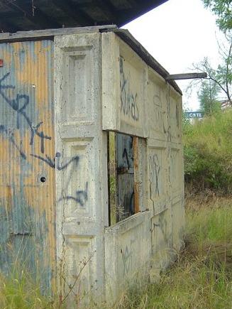 Remains of a pre-cast concrete electrical hut (Dunheved Station, 2006). Photo: nswrail.net