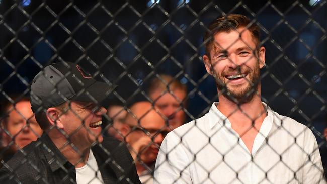 Chris Hemsworth and Matt Damon share a laugh during UFC234 at Rod Laver Arena. (Photo: Getty Images)