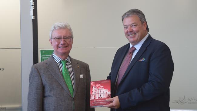 Queensland Governor Paul de Jersey (left) presents Whitsunday Mayor Andrew Willcox with a copy of The Governors of Modern Queensland at a community event at the Proserpine Council Chambers. Photo: Elyse Wurm