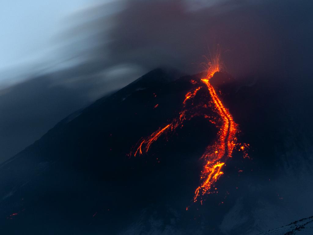 Mount Etna in Sicily has roared back into spectacular volcanic action, sending up plumes of ash and spewing lava but towns and cities are not yet being evacuated. Picture: AP Photo