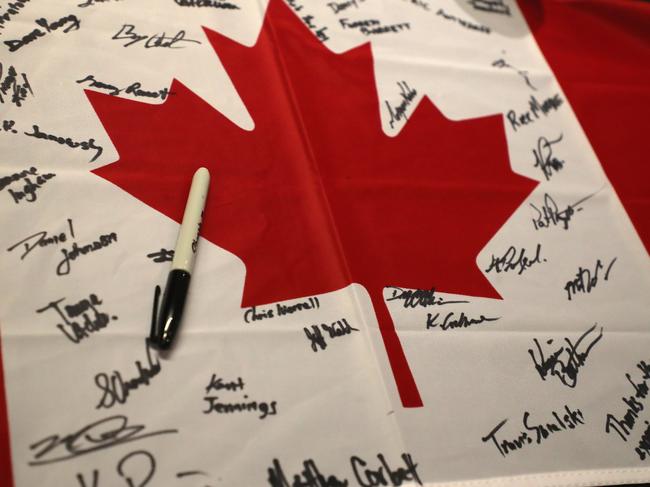 A Canadian flag signed by the firefighters is seen during a farewell to at Novotel Sydney Airport. Picture: AAP