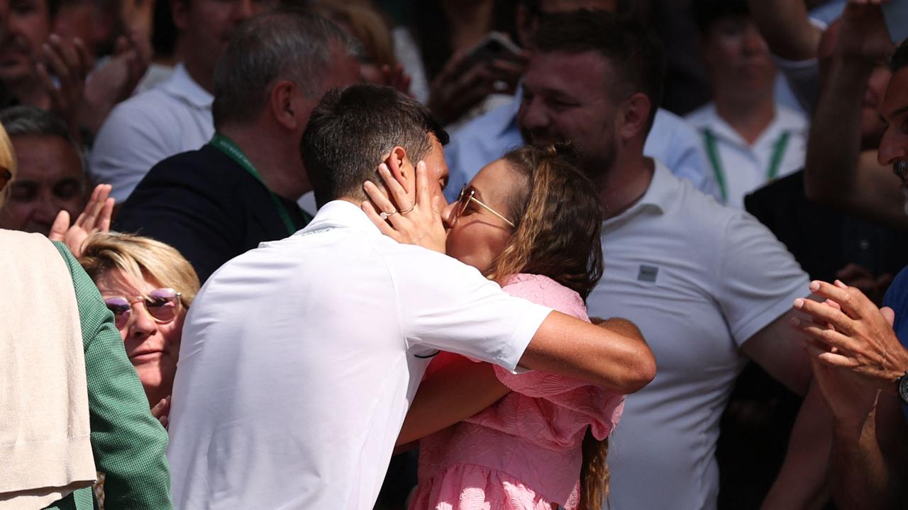 The happy couple sealed victory with a kiss. (Photo by Adrian DENNIS / AFP)