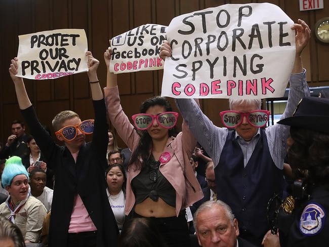 Protesters attend the hearing where Facebook co-founder, Chairman and CEO Mark Zuckerberg testified before a combined Senate Judicary and Commerce committee. Picture: Getty