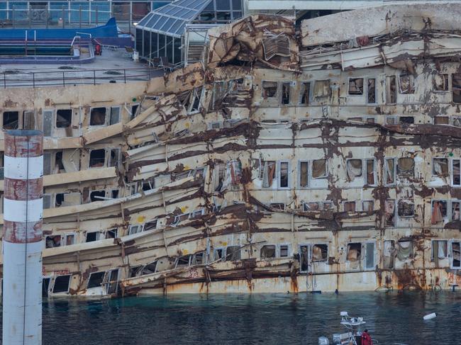 Large cruise ship in a repair dock in the port of Genoa. Cranes- machinery there . City Genoa behind in overcast , last days of summer,Wreck of Costa Concordia Ship in Genoa Harbor,Wreck of Costa Concordia Ship in Genoa Harbor,Wreck of Costa Concordia Ship in Genoa Harbor,Giglio Island, Italy - October 18, 2013: Side view of the wreck of Costa Concordia after the Parbuckling, a project that has made possible the rotation of the ship after the sinking in Giglio Island. The intense activities continue day and night to make possible the refloating and the removal of the wreck in short times.,Giglio Island, Italy - October 17, 2013: The damaged area of the wreck of Costa Concordia after Parbuckling, a project that has made possible the rotation of the ship after the sinking in Giglio Island.,Giglio Island, Italy - September 26, 2013: remains of the tragic sinking of Costa Concordia: this is how it looks after the recent successful parbuckling.