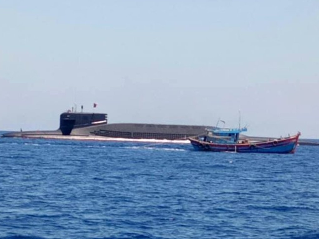 An unverified photo of a Chinese Type 094 nuclear-powered submarine surfacing beside a Vietnamese fishing vessel. Picture: DuanDang/Twitter