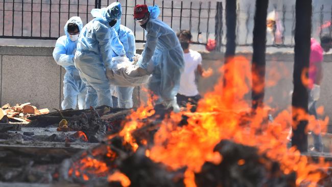 Relatives carry the body of a COVID-19 victim for cremation, at Seema Puri crematorium, in New Delhi, India. Picture: Getty Images