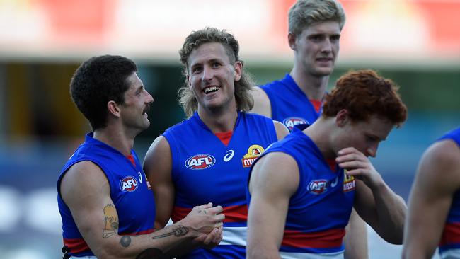 Aaron Naughton of the Bulldogs celebrates victory over Adelaide with Tom Liberatore at Metricon Stadium. Picture: Getty Images