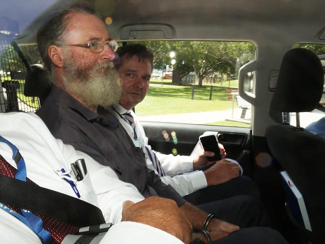 Potter was flanked by detectives as he made his way to Cairns Airport. Picture: Liam Kidston