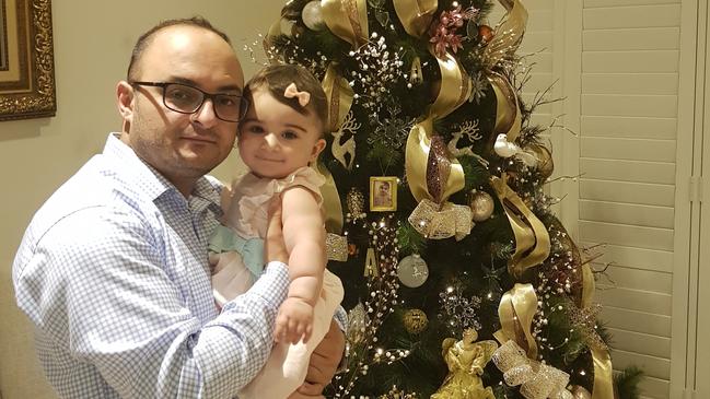 Jozef Maragol and his daughter Maragol at her first and only Christmas.