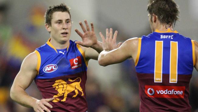 James Polkinghorne celebrates kicking a goal with Justin Sherman.