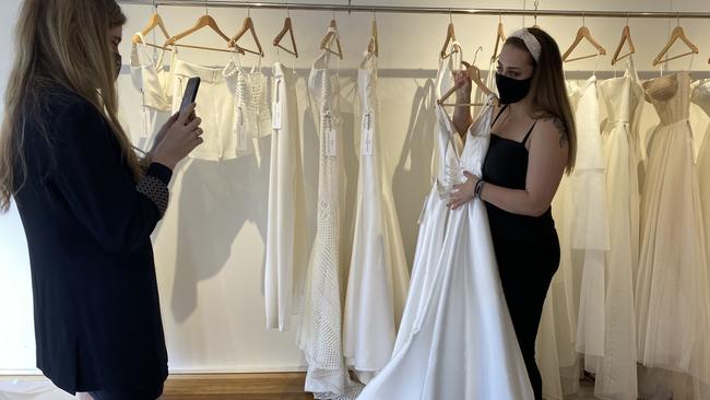 Staff at Karen Willis Holmes can now see brides in person but have continued to use social media to connect to couples outside the 25km radius. Picture: Grace McKinnon