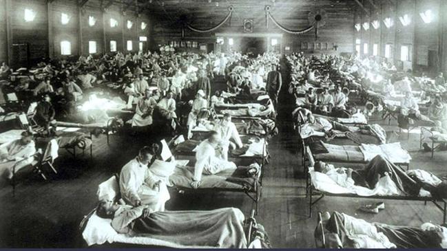 Soldiers from Fort Riley, Kansas, suffering from Spanish flu are hospitalised in a converted building at Camp Funston in 1918