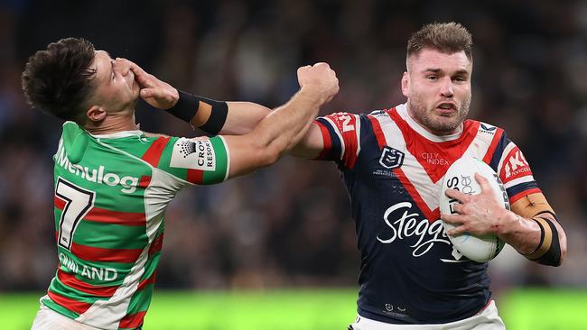 Angus Crichton puts a huge fend on Lachlan Ilias. Picture: Getty