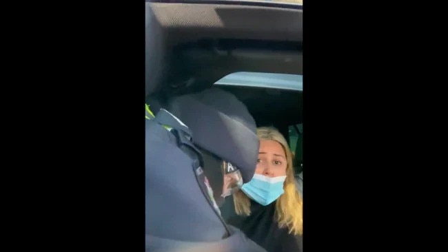 Natalie Bonett shared a video of the moment police drag her from her car at a coronavirus checkpoint. Picture: Facebook