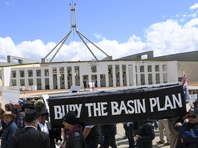 Farmers carry a coffin with the words "Bury the Basin Plan' as they attend the 'Can the Murray-Darling Basin Plan' rally outside Parliament House in Canberra, Monday, December 2, 2019. (AAP Image/Lukas Coch) NO ARCHIVING