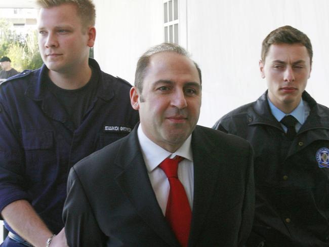 04/03/2008 WIRE: Australian drug fugitive Tony Mokbel, center, arrives at a court in Athens on Tuesday, March 4, 2008. The 41-year-old Australian was arrested in June 2007 near Athens after skipping bail last year while on trial for drug smuggling. He was sentenced on that offense in his absence, receiving up to 12 years in prison, and also faces two murder charges in Australia. (AP Photo/Thanassis Stavrakis)