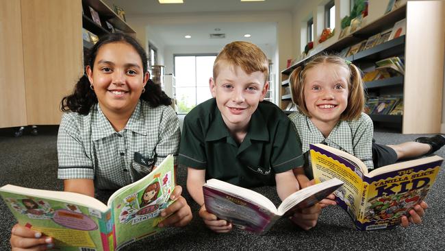 Brisbane primary schools are seeing rising enrolment numbers. St Ita’s Catholic Primary School students Velecia Hynes, 9, Sam Toshack, 11 and Charlotte Zwart. Pic: AAP/Josh Woning