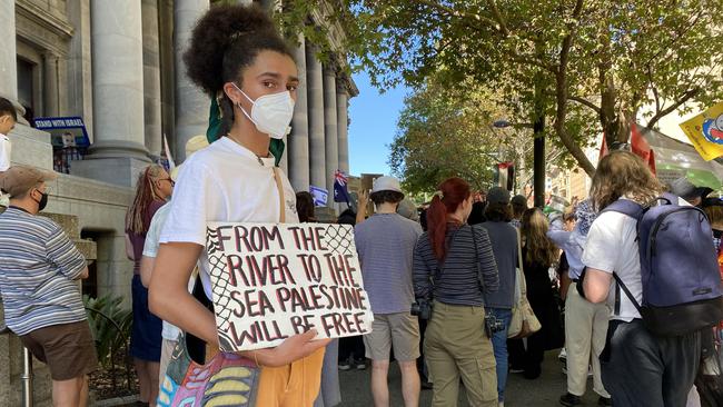 TJ, a supporter of Palestine holds up a sign with the words, “From the river to the sea, Palestine will be free’, as a stand of “resistance”.