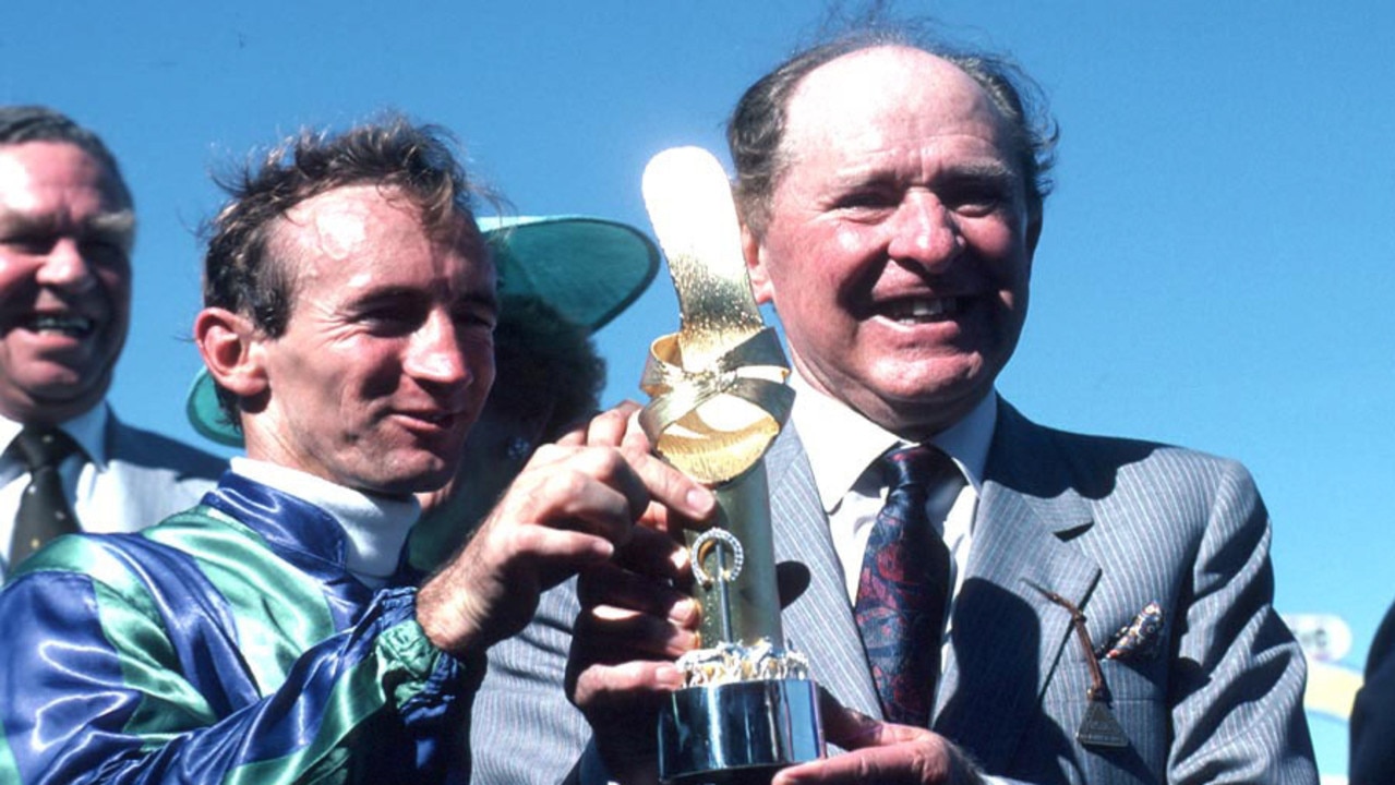 Aust racehorse trainer Tommy Smith with jockey Mick Dittman holding Golden Slipper trophy won by Bounding Away trophy in 1986.