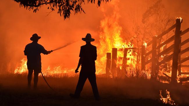 Residents defending a property from a bushfire at Hillsville near Taree, 350km north of Sydney, in 2019. Picture: AFP