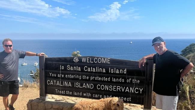 *Brian Houston and his dog Lido, along with a friend at the sign for Santa Catalina island, an hour's boat ride from Los Angeles.