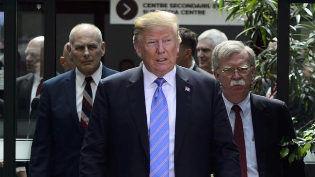 President Donald Trump leaves the G7 Summit in La Malbaie, Quebec, with White House chief of staff John Kelly, left, and National Security Adviser John Bolton. Picture: AP