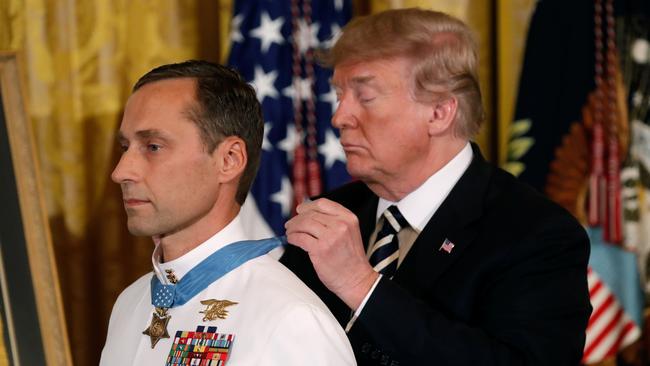 Britt Slabinski receives the Medal of Honour from Donald Trump. Picture: Reuters