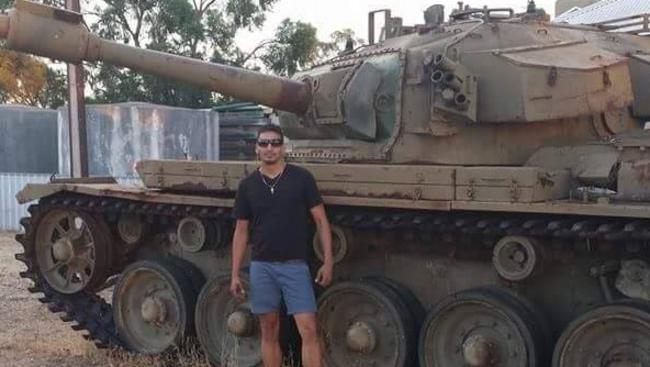 Gargasoulas in front of a tank.