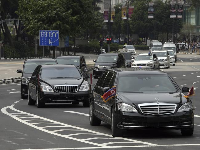 The North Korean motorcade, believed to be carrying North Korean leader Kim Jong-un travels along Singapore's Orchard Road. Picture: AP/Joseph Nair