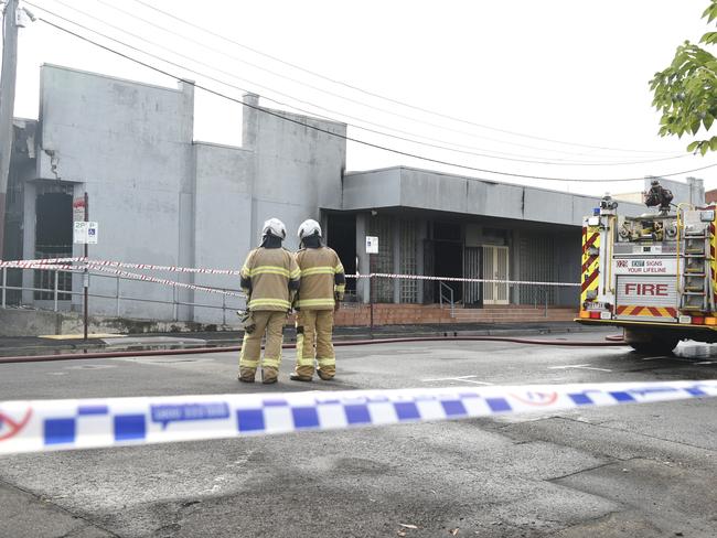 Fire crews and police inspect the burnt-out synagogue. Picture: Andrew Henshaw