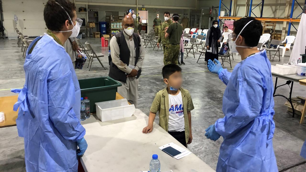 Australian Defence Force personnel process the first evacuees from Kabul.