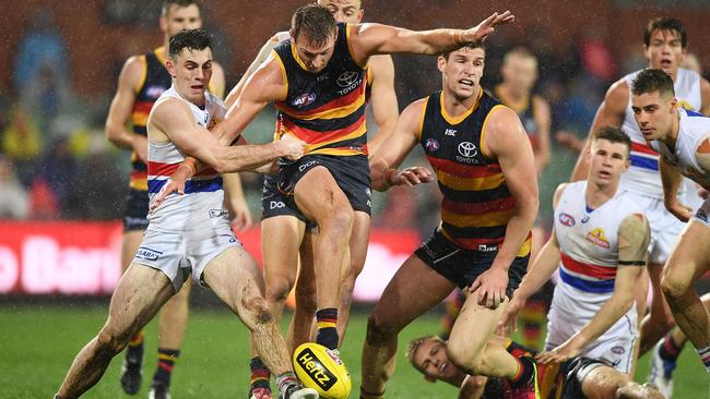 Daniel Talia gets a kick away before being tackled by Toby McLean.