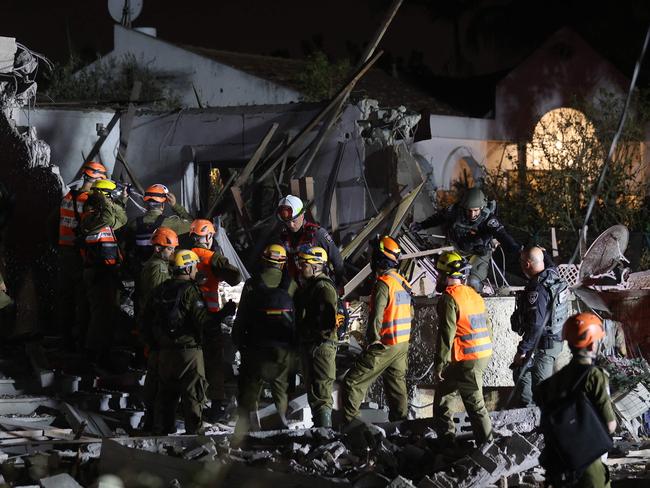 Members of the Israeli security forces check a house that was damaged by a rocket fired from the Gaza Strip in Lod, on the outskirts of Tel Aviv. Picture: AFP